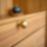 Elegant three-inch gold drawer pull on a wooden cabinet